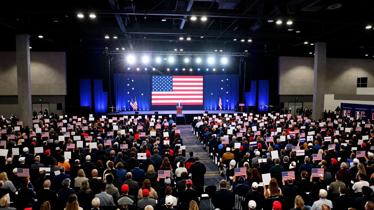 A photorealistic view of a crowded convention hall with patriotic decorations and a spotlighted stage during a major political gathering.