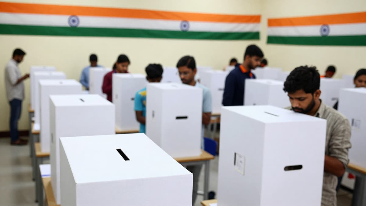Diverse voters casting ballots at an Indian polling station with tricolor flags.
