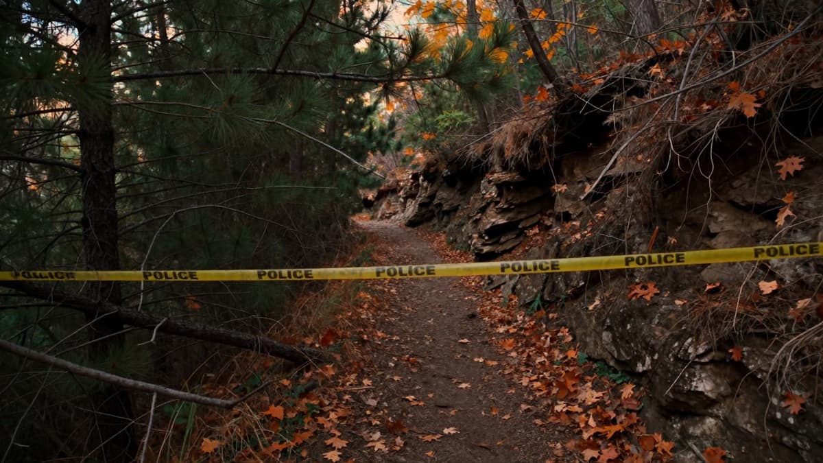 A shadowed, rugged trail in American Fork Canyon with weathered police tape symbolizing a 1974 cold case closure.