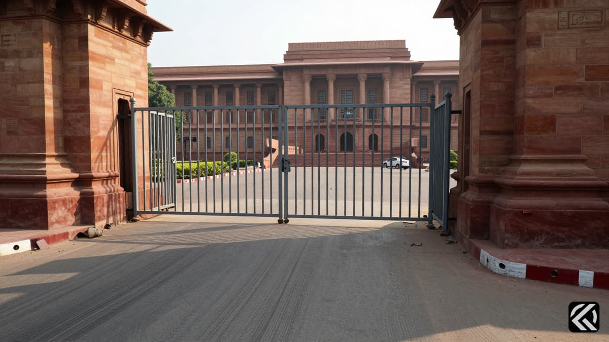 Damaged metal gate and stone pillars at Delhi Assembly entrance following a security incident.