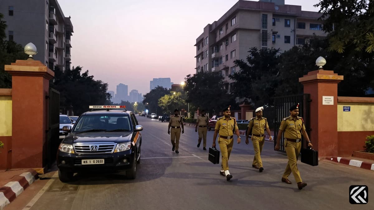 Assam Police officers arriving at a Delhi residence for an official search operation regarding political allegations.