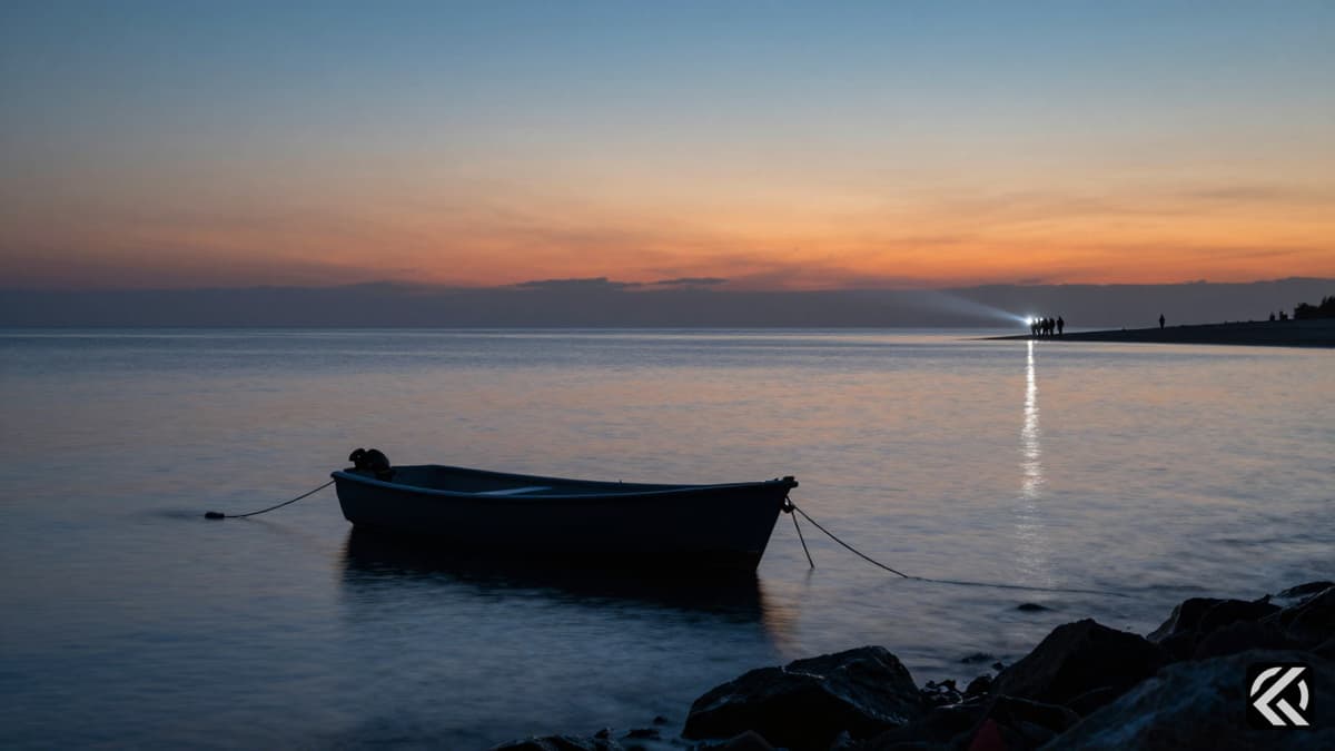 A small dinghy floating alone on the water during a twilight search operation near the Bahamas coast.