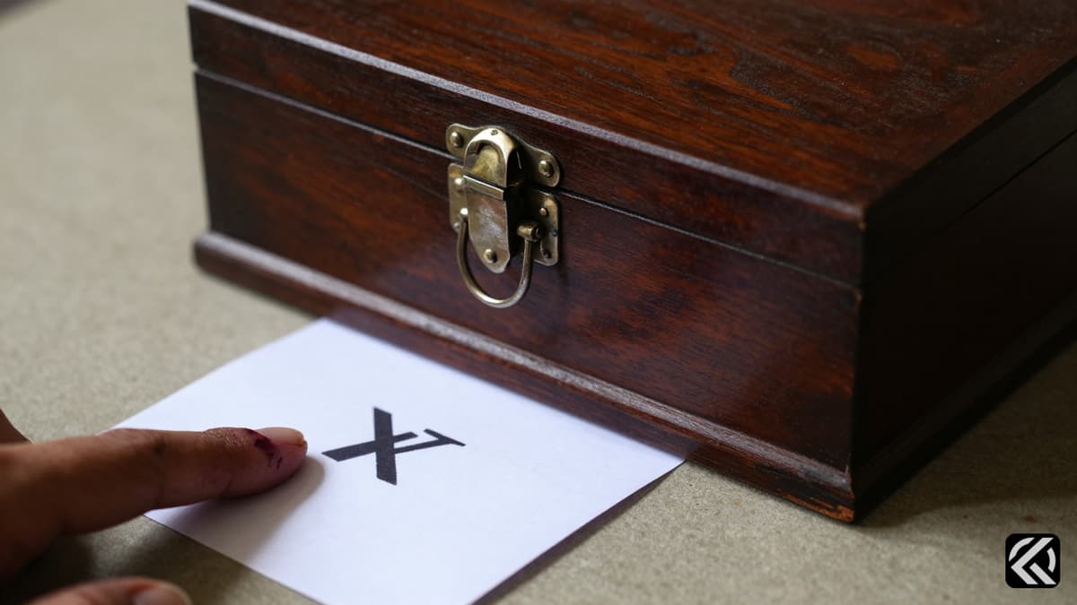 Wooden ballot box and inked finger symbolizing voting in a major election