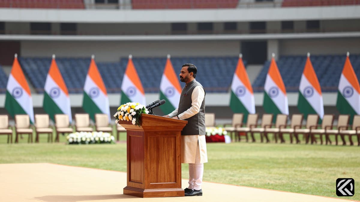 Empty ceremonial stage with podium and Indian flags for Tamil Nadu political swearing-in