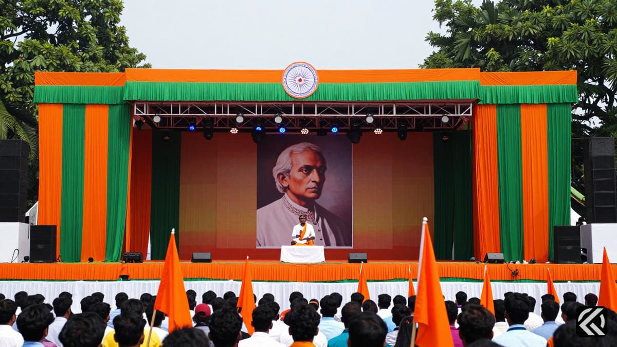 Grand ceremonial stage with Tagore portrait and saffron banners at Kolkata's Brigade Parade Ground.
