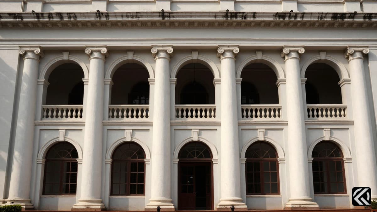 Exterior view of a grand colonial courthouse with pillars and arches.