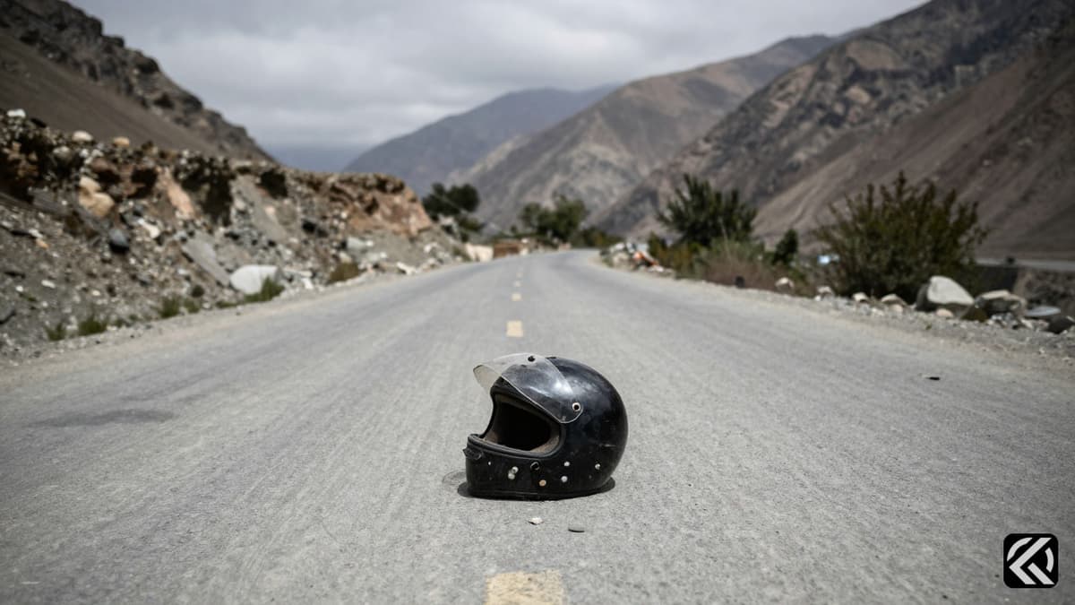 Motorcycle helmet on mountain road symbolizing assassination in POK