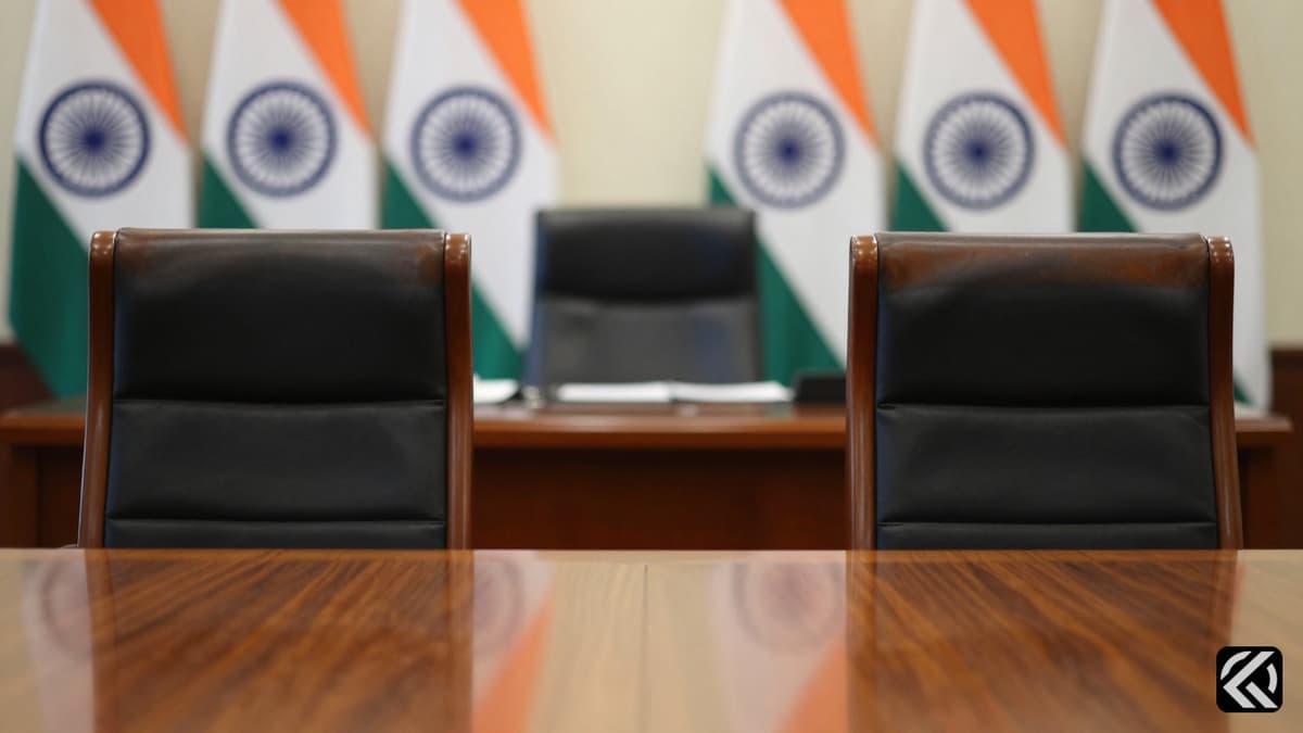 Empty chairs at a desk symbolize political power shift in Karnataka.