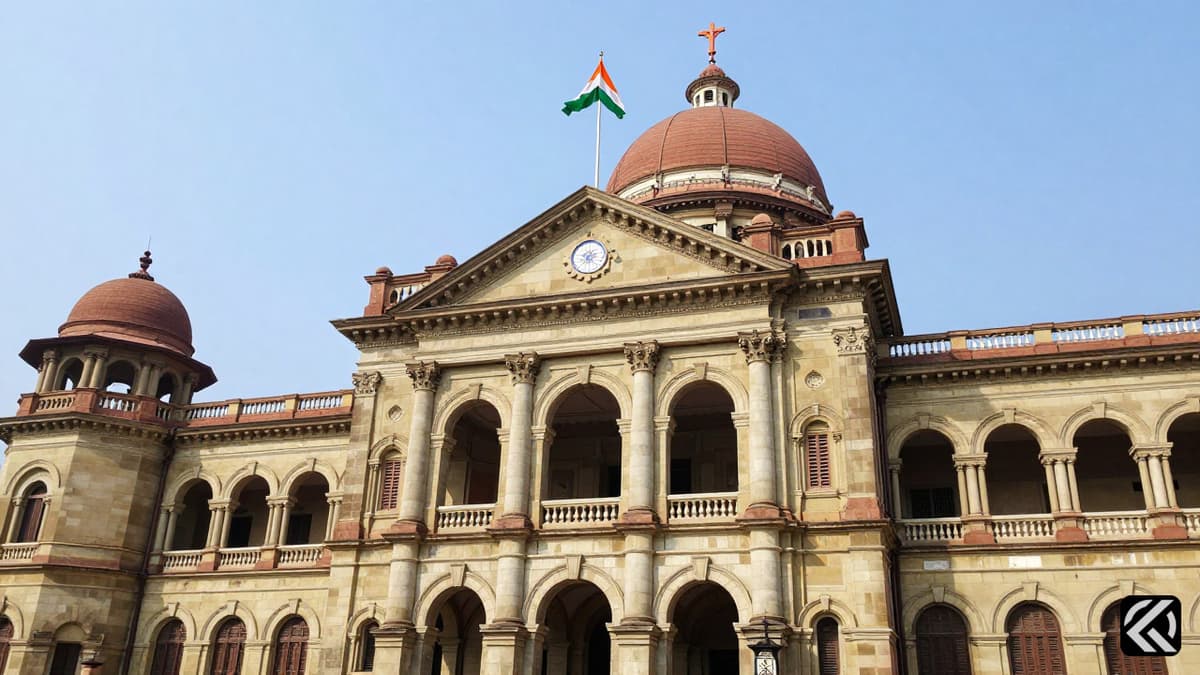 Lok Bhavan government building in Kolkata with Indian flags flying outside under a clear blue sky.