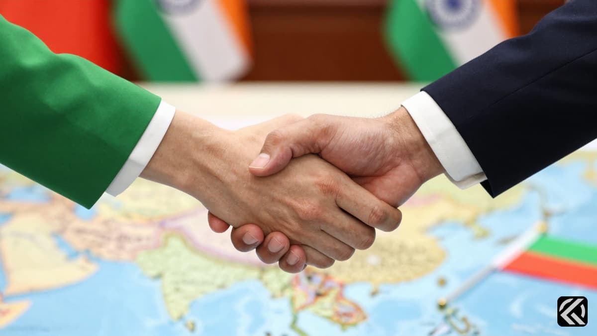 Hands shaking over a map with Indian and Myanmar flags on a diplomatic desk